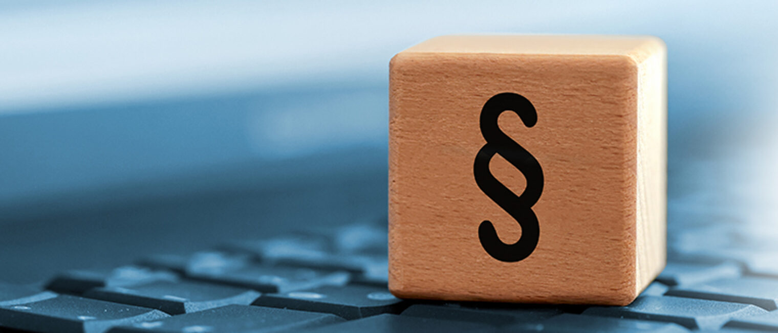 Close up of black paragraph character on wooden block on computer keyboard