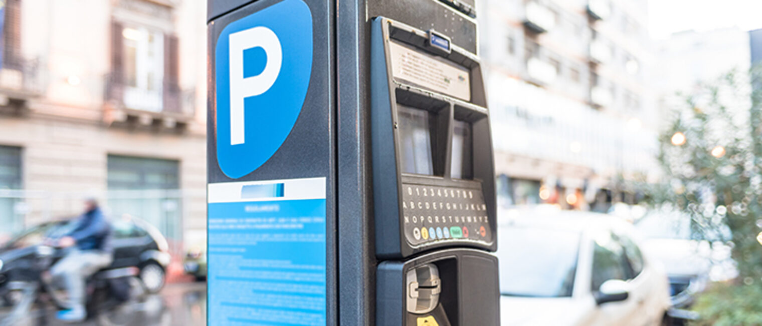 Parking meter on a city street operated with cash and credit cards.