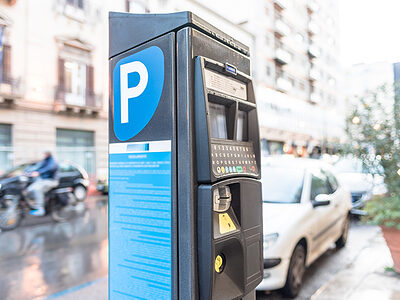 Parking meter on a city street operated with cash and credit cards.
