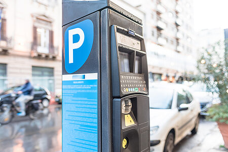 Parking meter on a city street operated with cash and credit cards.