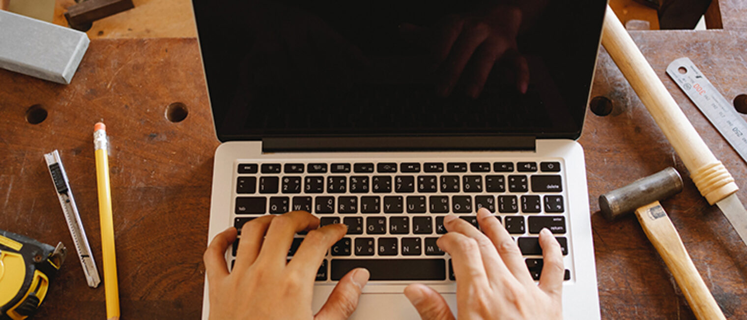 aufgeklappter Laptop, zehn Finger tippen