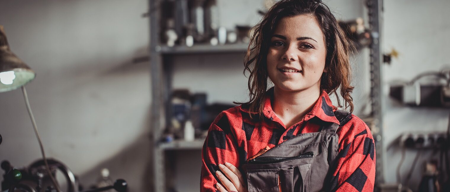 Portrait of a young woman in a workshop