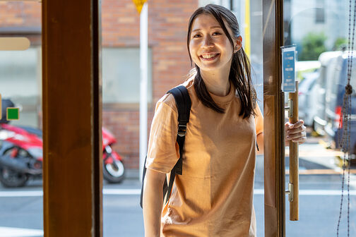 junge Frau betritt ein Geschäft