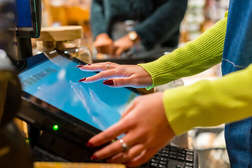 Finger tippen auf einem Kassenbildschirm